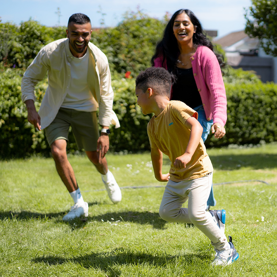 A family running and playing in a garden