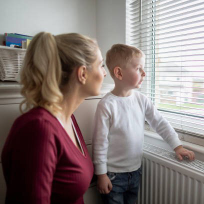 A woman and child looking out of a window